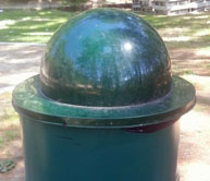 A garbage can with a spherical top