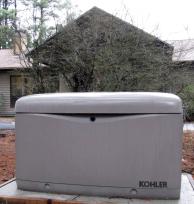 Kohler generator, on a concrete pad in front of the house