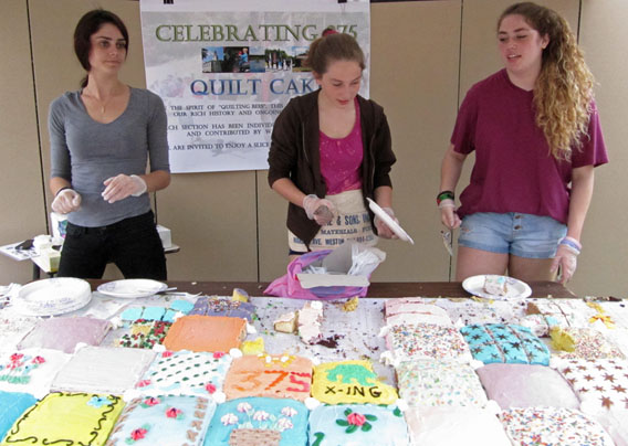 Three women starting to cut the cake