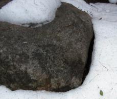 Gap between a rock and the surrounding snow