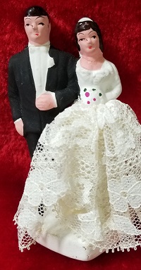 Small ceramic groom and bride for the top of a wedding cake