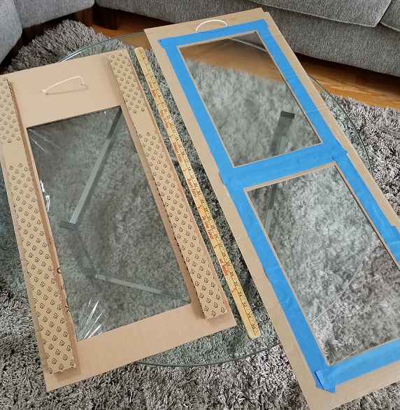 2 cardboard frames with panes of clear plastic