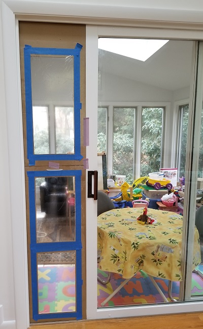 The cardboard frames installed in an opening in the sliding glass door