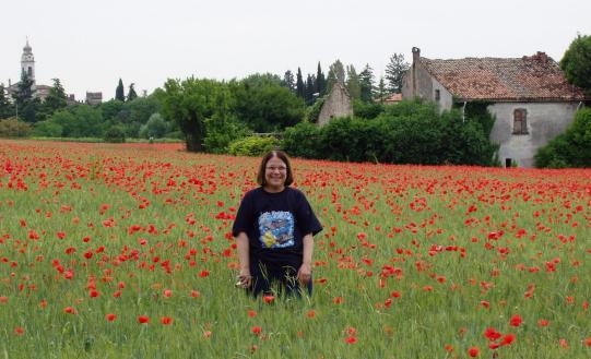 Margie standing in a field of poppies